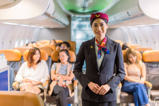 istock Portrait of cabin crew with passengers in background. 1408373501