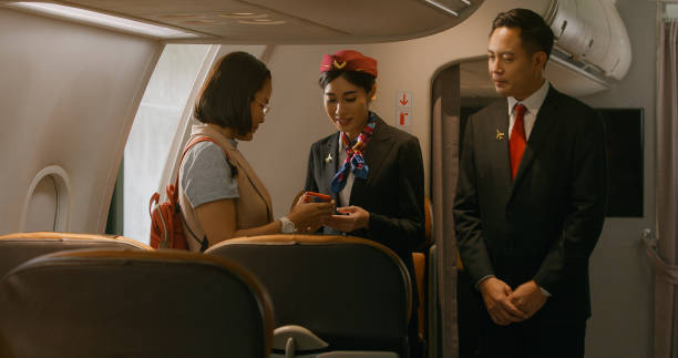 istock Boarding the plane, cabin crew helping. 1408374069