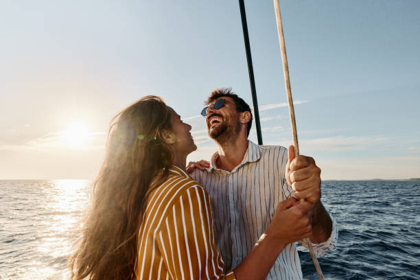 istock Cheerful couple having fun in summer day on a boat. 1408374231