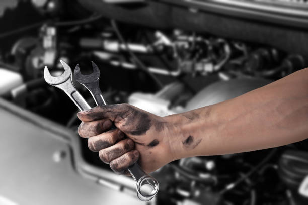 istock Auto mechanic with wrench near broken down car, closeup 1408374536