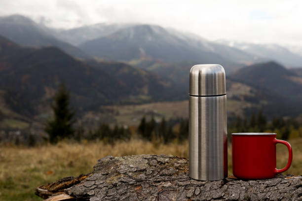 metallic camping thermos on beautiful autumnal background