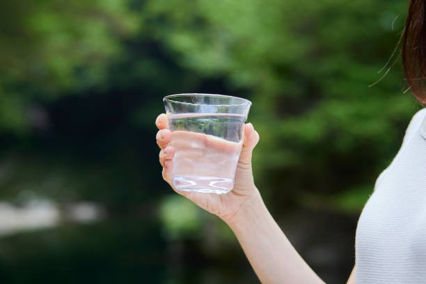istock Woman with water in a cup in nature 1408376167