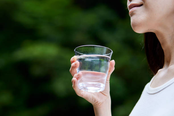 istock Woman with water in a cup in nature 1408376171