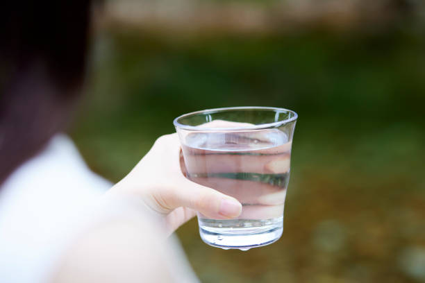istock Woman with water in a cup in nature 1408376178