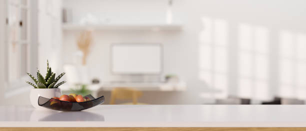 istock Modern white tabletop with copy space over blurred modern home workplace in the background. 1408377136