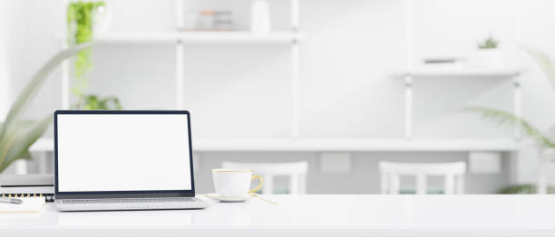 istock Laptop mockup and copy space on tabletop over blurred white co-working space in the background 1408377177