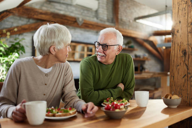 istock Happy mature couple communicating during breakfast time in dining room. 1408377193
