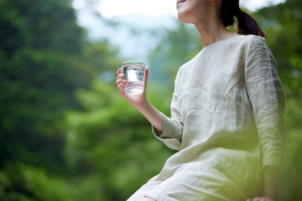 istock Woman with water in a cup in nature 1408377372