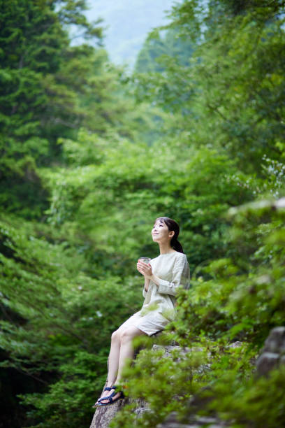 istock Woman with water in a cup in nature 1408377406