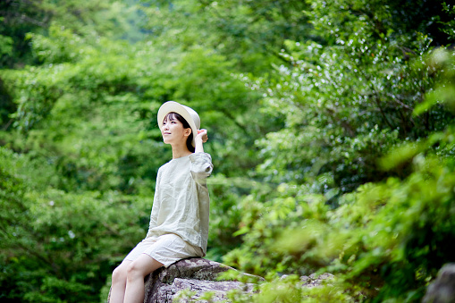 Straw hat with a Japanese woman standing in nature