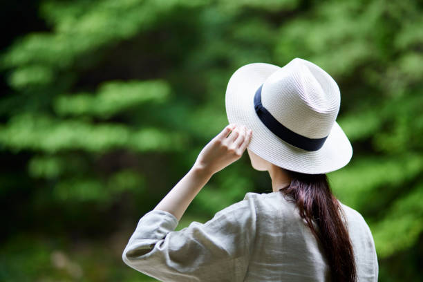 Straw hat with a Japanese woman standing in nature