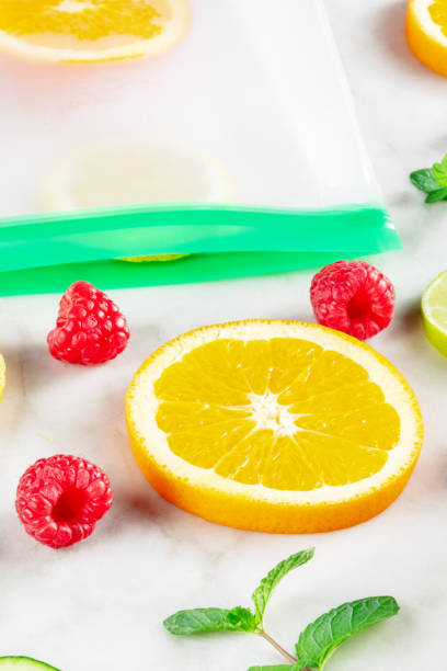 istock Food storage bags with fruit and vegetables, on a white marble kitchen table 1408383275