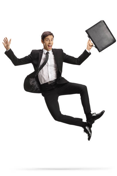 istock Successfull young businessman with a briefcase jumping 1408383936
