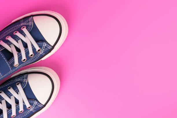 istock a pair of blue sneakers on a pink background 1408385278