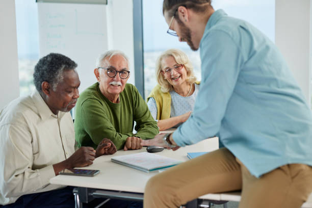 istock Multicultural group of senior students asking questions their tutor who showing them solution. 1408387503