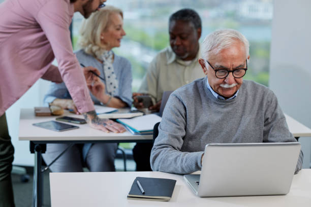 istock Small multiracial group of senior students in a classroom asking for explanation their teacher. 1408387710