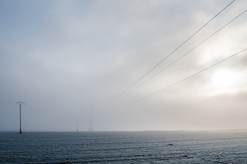 Network of electrical cables in a foggy atmosphere