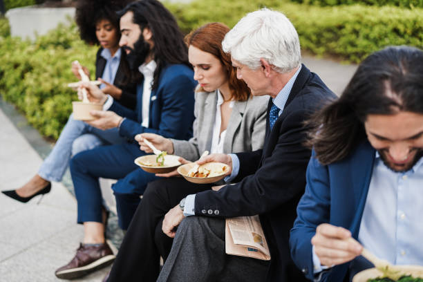 istock Diverse business people doing lunch break outdoor from office building 1408387898