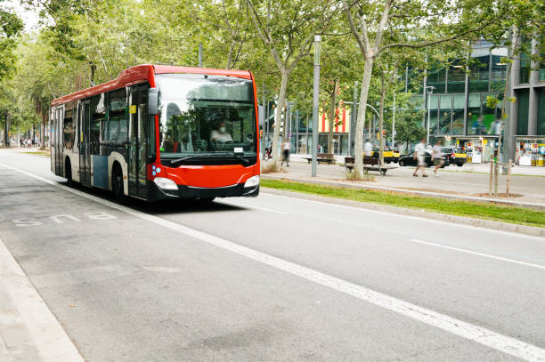 A red city bus in an urban street