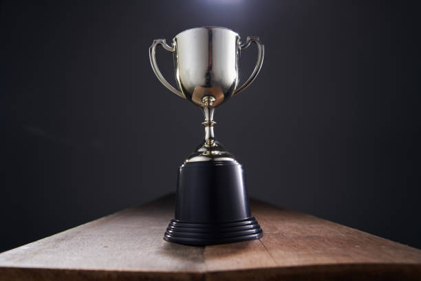 istock gold trophy against black background 1408394707