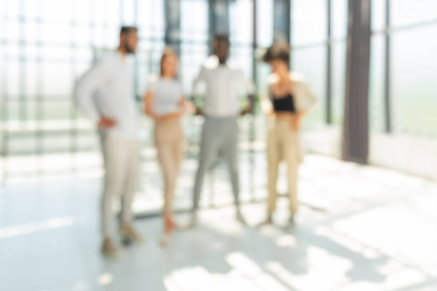 istock Blurred image of business people standing in the office 1408394748