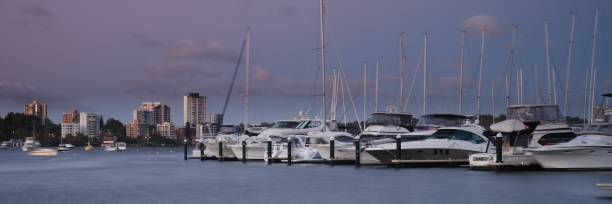 istock Boats at dusk with city skyline 1408395266