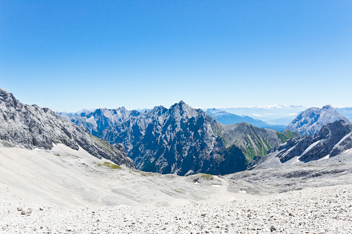 Achievement of male hiker standing with enjoying the Mont Blanc mountain range view during trail of Lac Blanc, French Alps, France