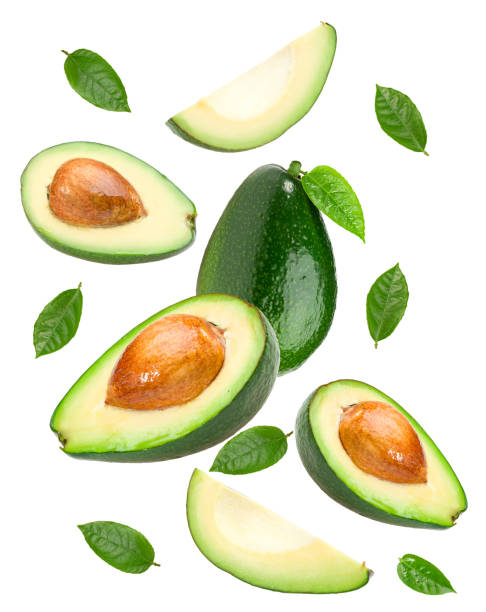istock flying avocado with green leaves isolated on white background. clipping path 1408398601
