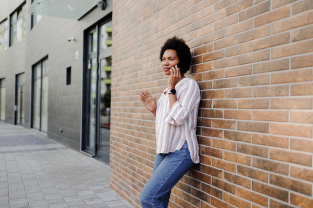 istock Angry woman using phone on the street 1408402009