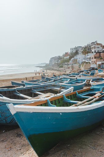 Blue traditional Boats on a beach located in Taghazout, Morocco