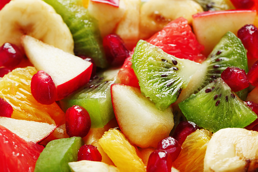 Pieces of raznfh fruit close-up in full screen, Fruit salad. Slices of fresh and healthy fruits for a healthy diet.