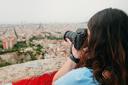 Photographer taking a picture of a city from above. Barcelona, Spain