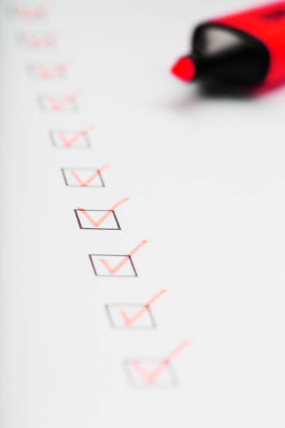 istock Orange marker with markers on the checklist sheet. 1408404041