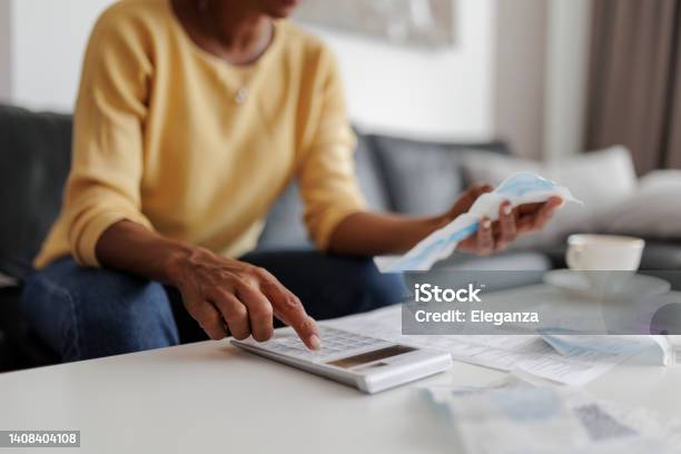 Close Up Of A Mid Adult Woman Checking Her Energy Bills At Home Sitting In Her Living Room She Has A Worried Expression Stock Photo - Download Image Now