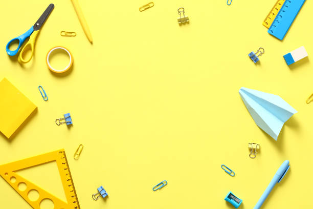 istock School supplies on yellow background. Flat lay, top view, copy space. Minimal style. 1408405565