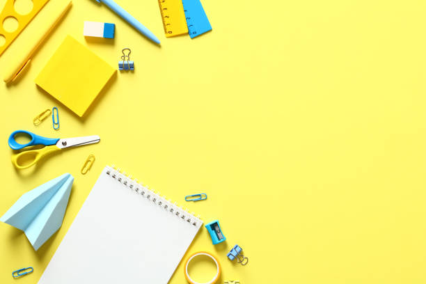 istock Back to school concept. Schools supplies on yellow background top view. Flat lay notepad, scissors, sticky, clips, pen, ruler. 1408405574