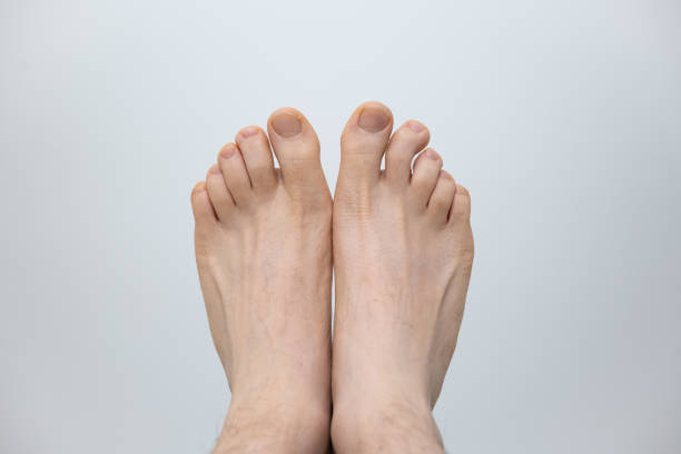istock Caucasian male bare feet isolated against white background, Close up front shot, unrecognizable person 1408408882