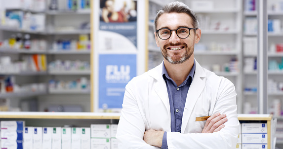 Copyspace alongside a happy pharmacist standing with arms crossed while working in a chemist. Mature caucasian man and drugstore manager ready to assist customers with trusted pharmaceutical advice