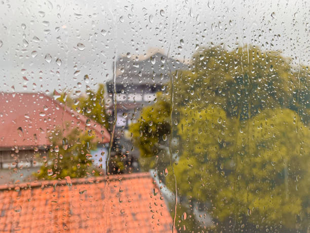 istock reflection rain water flowing on the glass 1408409091