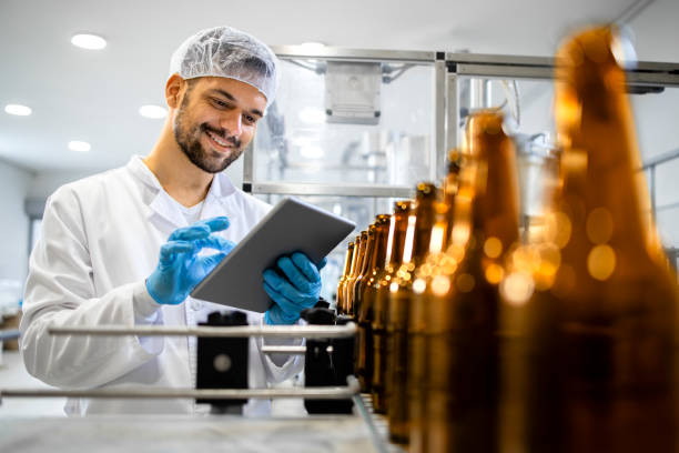 istock Beer bottling plant and factory worker controlling alcohol beverage production before distribution. 1408409295