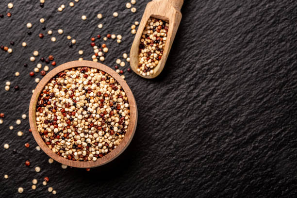 istock mixed three varieties of raw quinoa, South American grain on a stone background. Restaurant menu, dieting, cookbook recipe 1408411355