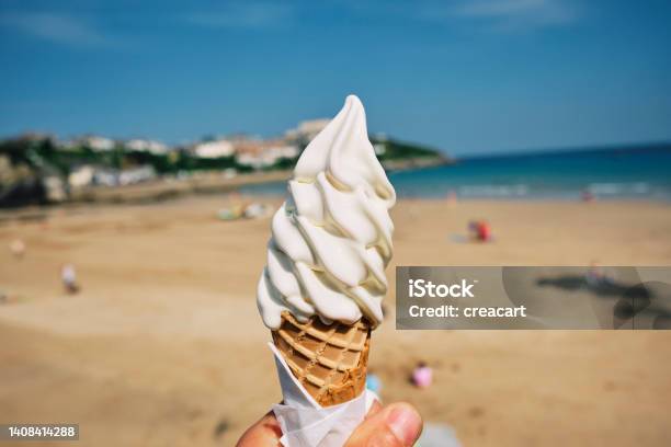 Hand Holding An Ice Cream At Town Beach Newquay Cornwall On A Sunny June Day Stock Photo - Download Image Now