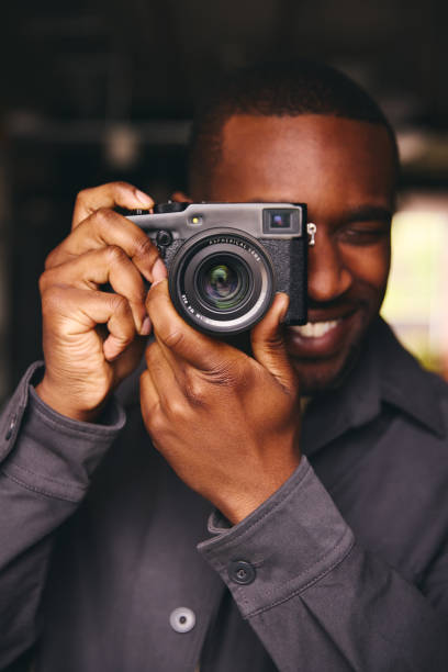 istock Photographer Taking A Picture With Camera Looking Through Lens 1408417707