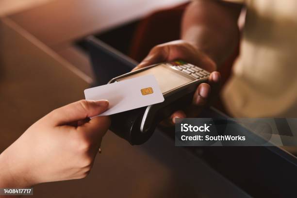 Close In Of Sales Assistant In Retail Shop With Customer Paying Using Contactless Payment Credit Card Nfc Stock Photo - Download Image Now