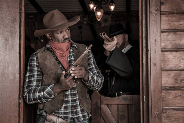 istock Handsome Black Cowboy with a priest in an authentic wild west setting 1408418283
