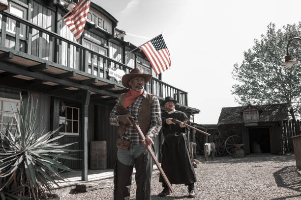 istock Handsome Black Cowboy with a priest in an authentic wild west setting 1408418328