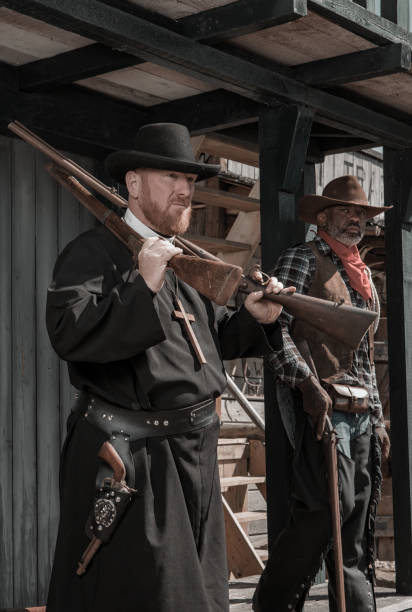 istock Handsome Black Cowboy with a priest in an authentic wild west setting 1408418598