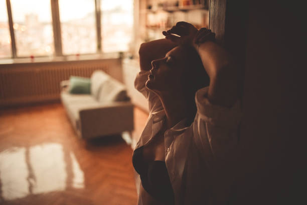 istock Young Woman Leaning On The Door Frame 1408419951