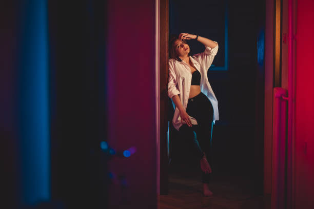 istock Young Woman Leaning On The Door Frame 1408420075