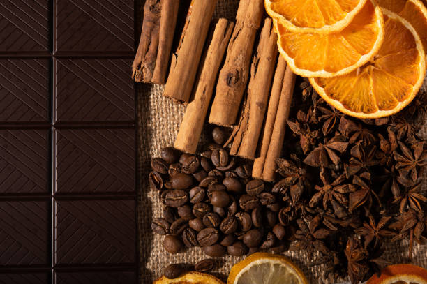Citrus fruit, cinnamon, star anise, coffee beans and dark chocolate, up close from above